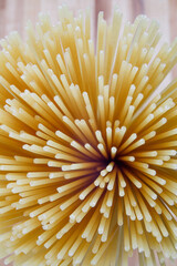 The bundle of spaghetti is photographed from the end. A bundle of spaghetti fan.