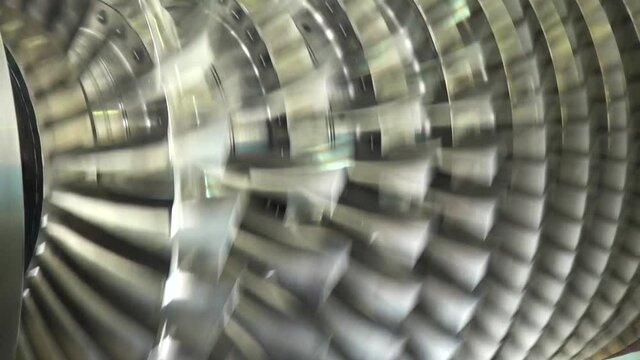 Balancing compressor rotor on bench. Repair of aircraft turbojet engines with afterburner. Compressor rotor is mounted on rack and rotates. Close-up. Vintage video from archive.