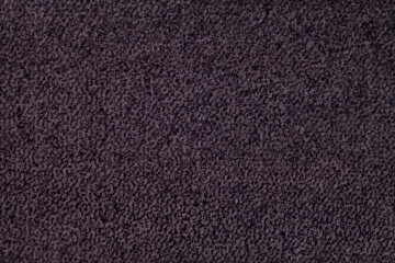 Dark purple fluffy background of soft, fleecy cloth. Texture of violet textile.