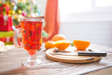 Mulled wine with spices on wooden background
