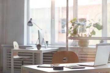 Image of empty modern office with desk with laptop