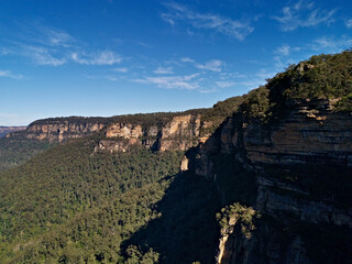 Fototapeta na wymiar Beautiful view of deep valleys and tall mountains, Wentworth Falls Lookout, Blue Mountain National Park, New South Wales, Australia 