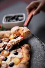 pizza in the oven with mushroom, olive oil, and tomatoes