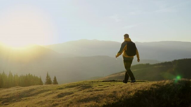 A man travels in the mountains. Beautiful nature of the Carpathian mountains. The concept of travel and active lifestyle. 4K