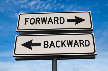 Forward vs backward. White two street signs with arrow on metal pole with word. Directional road....