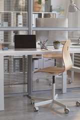 Turned off laptop on the table in empty office with no people inside