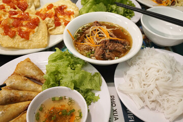 Vietnam food - Bun Cha – Vietnamese Grilled Pork with Noodle and sweet sauce with deep fried spring rolls at Pho xua Hoi an vietnam