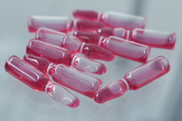 Ampoules with covid vaccine on a glass table