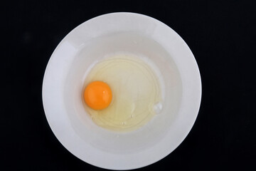 open egg with yolk ready to cook