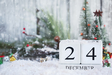 Christmas Eve. White wood calendar blocks with the date December 24th and Christmas decorations...