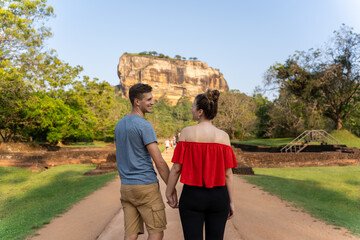 happy couple visiting the lion rock in the park in Sigiriya