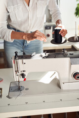 Woman seamstress sewing on sewing machine