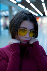 A girl with yellow glasses and short hair