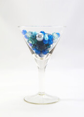 Round blue beads in a glass