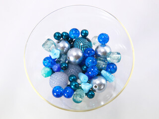 Round blue beads in a glass