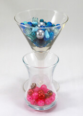 Blue and pink beads in glasses