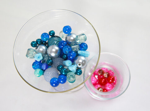 Blue and pink beads in glasses