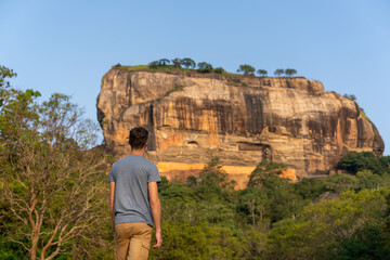 caucasian man visiting the lion rock in the park in Sigiriya