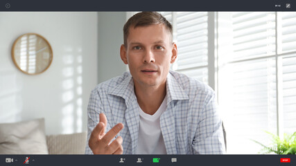 Man communicating with coworkers from home using video chat, view through camera