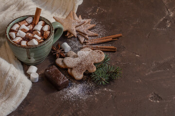 atmospheric Christmas composition, a cup of cocoa with marshmallows, gingerbread cookies, sweets, cinnamon, copy space..