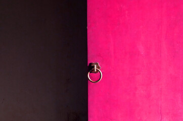 Pink wooden door with Dark gray cement wall and copy space at The Imperial City (Vietnamese: Hoang thanh) within the citadel (Kinh thanh) is Best Famous Landmark of the city of Hue Vietnam