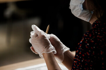 Obraz premium a man with gloves holding a pen, isolated work, protective equipment