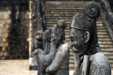 Fototapeta na wymiar Ancient Sculpture of Statues warriors in Royal Tomb of Khai Dinh King - black architecture Famous Landmark of the city of Hue Vietnam 