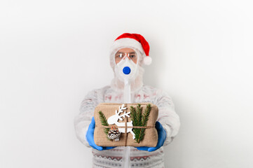 Delivery man holding gift box in eco-friendly reusable packaging on white background. He wearing protection costume, face mask, glasses and medical rubber gloves safety form coronavirus. Safe delivery