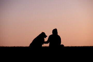 Fototapeta na wymiar silhouette of a person with a dog