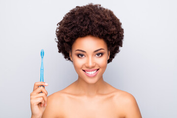 Close-up portrait of her she nice attractive cheerful wavy-haired girl holding in hand using new electric toothbrush advert ad caries treatment isolated on light white gray color pastel background