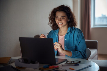 Happy young woman freelancer working online on computer laptop.