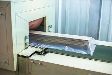 hardwood flooring planks being packed in wood production factory