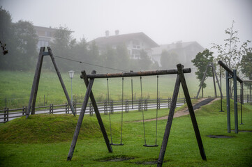 Empty children’s playground on a foggy summer morning