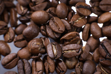 Coffee beans close up against the background of a coffee beans. Morning espresso. Coffee mug.	