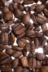 Coffee beans close up against the background of a coffee beans. Morning espresso. Coffee mug.	
