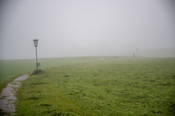 A wanderer on a path on a foggy morning