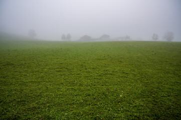 A village on the horizon in the fog