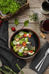 salad with fresh vegetables on a wooden restaurant table