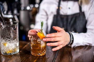 Girl barman makes a cocktail on the public house
