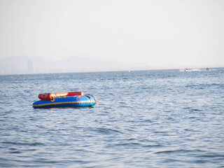 Fototapeta premium A rubber boat floating in the sea