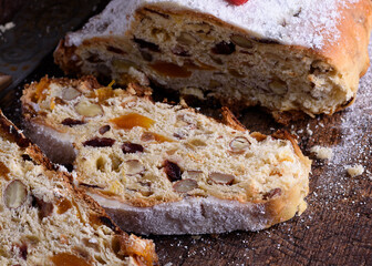Stollen, a traditional European cake with nuts and candied fruit, is dusted with icing sugar