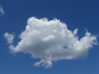 Big soft lonly cloud on the blue clear sky
