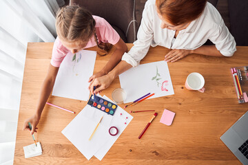 Mom drawing pictures with daughter