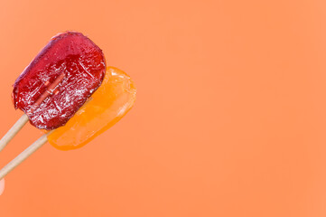 Closeup shot of lollipops on an isolated orange background