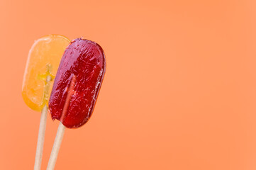 Closeup shot of lollipops on an isolated orange background