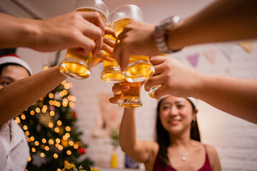 Group of Asian people are very happy and enjoy at the party. Close-up of people cheering of beer at a party.