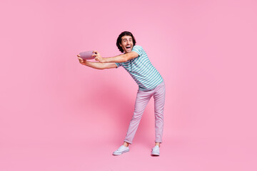 Full length photo of dancing cute young gentleman wear casual outfit holding arms modern device...