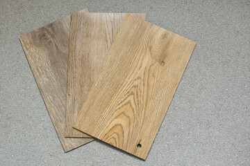 Choosing vinil wooden flooring material. Deciding and home concept with copy space.