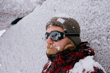 Fototapeta na wymiar Portrait of a male traveler in the winter forest