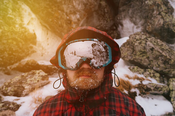 Portrait of a male traveler in the winter forest
